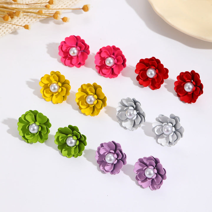 Ladies earrings with elaborate floral designs and pearl accents Nin Boutique