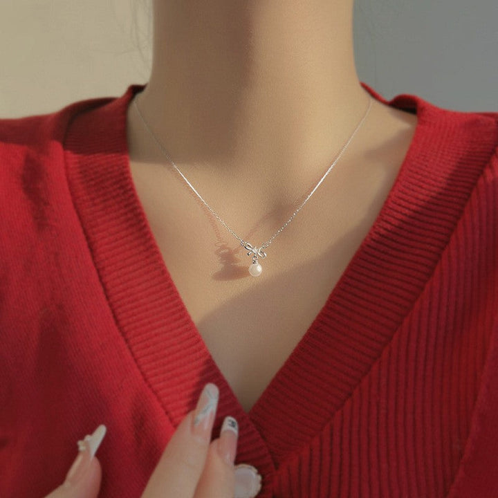 Women's necklace with elegant bow and pearl decoration Nin Boutique