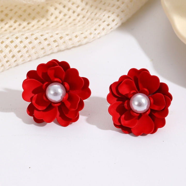 Ladies earrings with elaborate floral designs and pearl accents Nin Boutique
